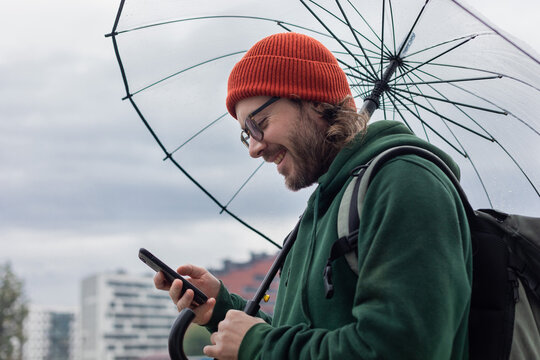 hipster under umbrella smiling