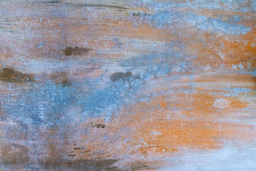 Aged blue and orange cement wall with black mold