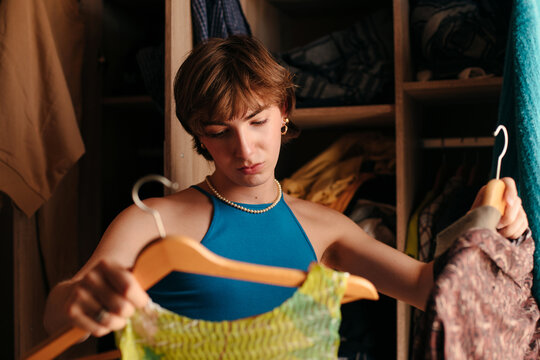 Queer teen organizing his wardrobe