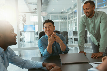 Group of multiethnic business people working together on project while sitting in modern office