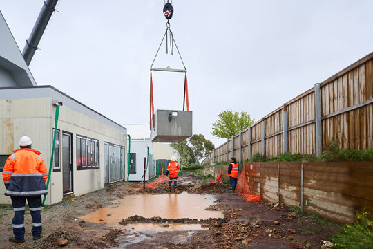 Spa pool being lowered into place by crane