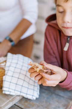 close up of a boy eating a slice of bread 