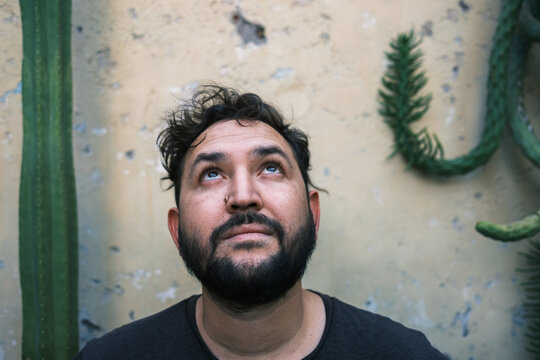 portrait of man with surprised face looking at the sk