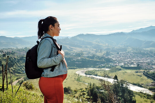 Portrait of a pregnant woman from a mountain top