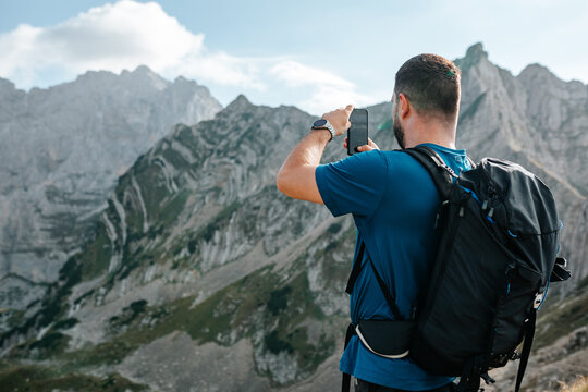 Man Taking Photos In Mountains.
