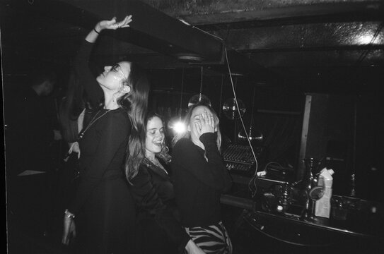 Three friends dancing in a nightclub