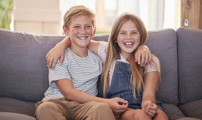 Family, children and sister and brother relax on a sofa, happy and laughing in their home together. Portrait, kids and siblings bond in a living room, sharing joke and close relationship in Amsterdam