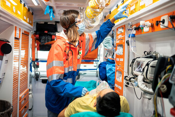 Paramedic woman working in ambulance