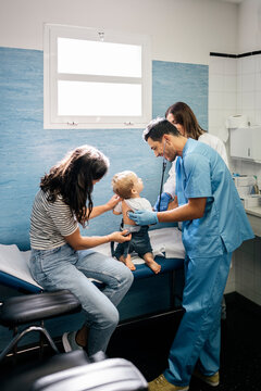 Pediatric Doctor Examining Little Patient