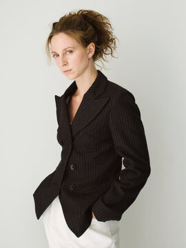 Woman in black jacket and white pants.
