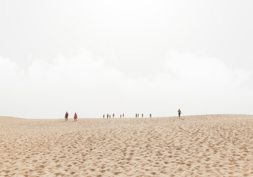 Desert landscape with people silhouettes walking around