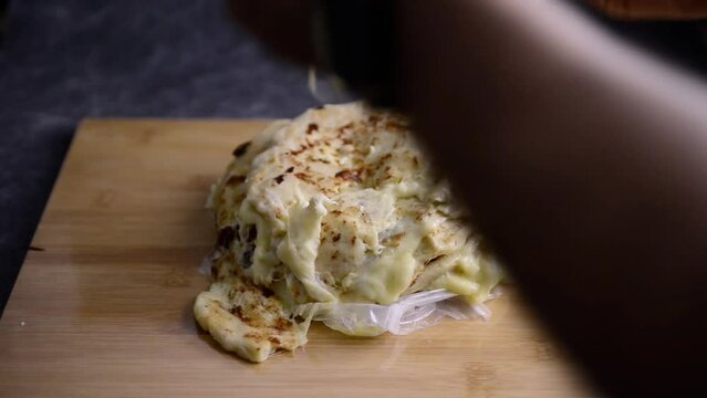 Video of a hand taking a cup of hot chocolate served with 2 pupusas and curtido. National Salvadoran national dish.