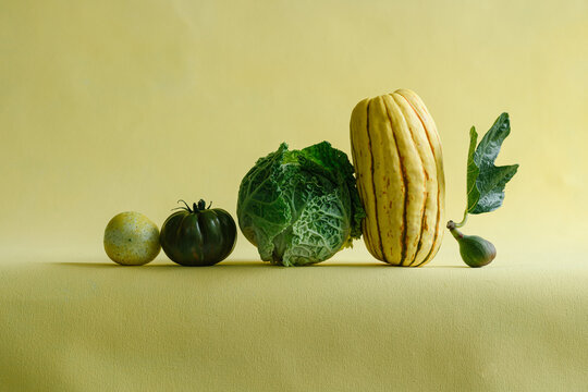 Still life of vegetables on yellow background