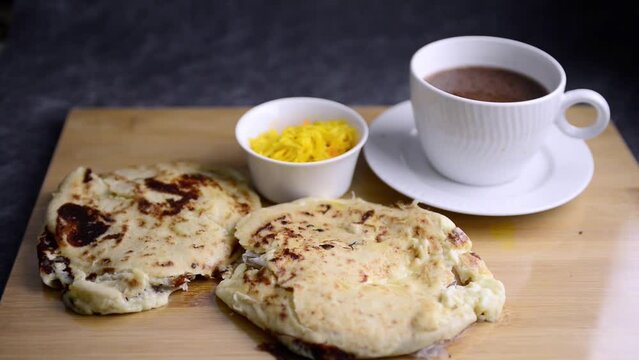Pupusas national Salvadoran dish lit by dimming morning light served wih curtido and hot chocolate
