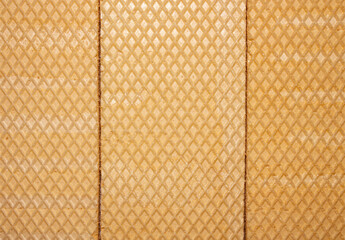 Waffle background.The texture of the waffle.Waffle surface close-up.Embossed waffle surface.