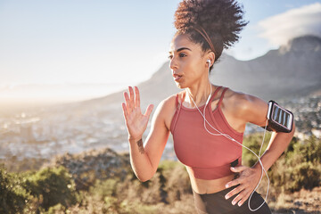 Earphones, fitness and black woman running in nature outdoors streaming music, radio or podcast for motivation. Health, wellness and female runner listening to audio, song and training sound track.