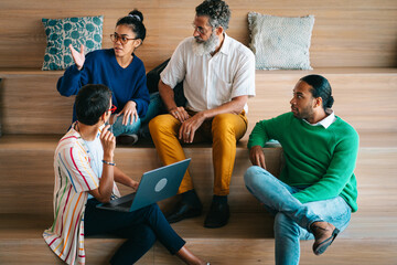 Group of colleagues having a meetup in creative co-working space