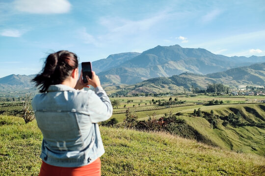 Woman taking a picture of the landscape