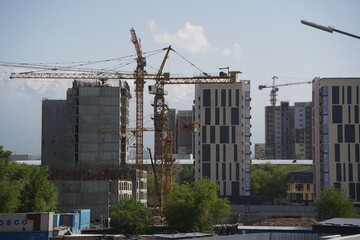 Almaty, Kazakhstan - 04.26.2022 : Construction of a high-rise residential complex near a road junction.