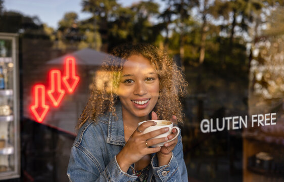 Happy woman with cup of coffee