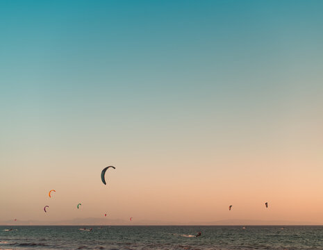 Kite surfers silhouettes during sunset