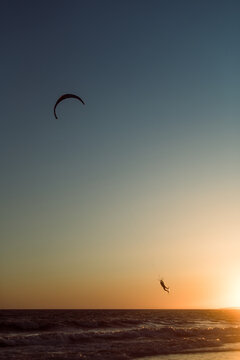 Kitesurf trick silhouette during sunset