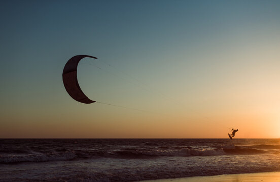 Impressive kitesurfer at beach shore