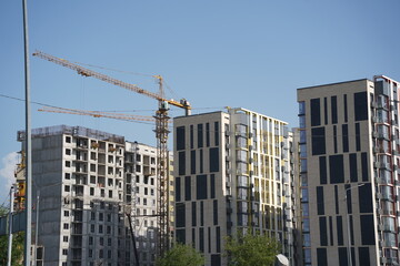 Fototapeta na wymiar Almaty, Kazakhstan - 04.26.2022 : Construction of a high-rise residential complex near a road junction.