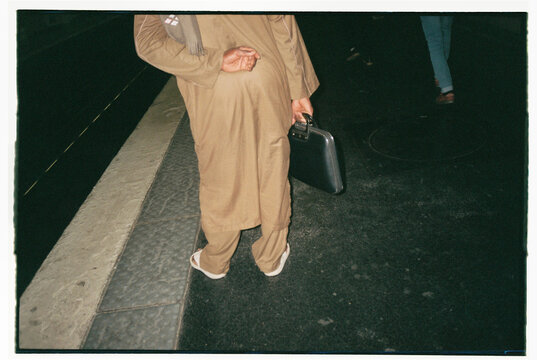 Anonymous businessman in train station with briefcase 