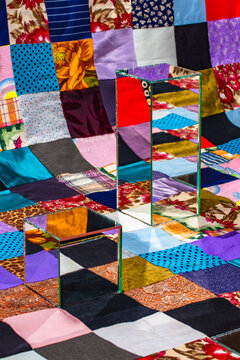 Conceptual background with mirror elements on a patchwork quilt