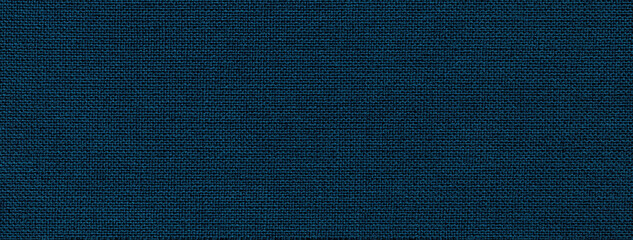 Texture of navy blue color background from textile material with wicker pattern. Structure of...