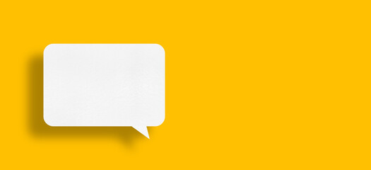 speech balloon shape white paper isolated on yellow background