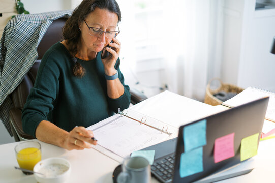 middle-aged woman working in home office
