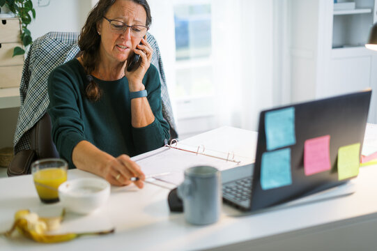 middle-aged woman working in home office