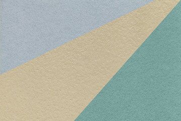 Fototapeta na wymiar Texture of old craft beige, blue and cool gray color paper background, macro. Vintage abstract cerulean cardboard.