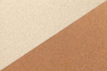 Texture of craft light beige and brown paper background, half two colors, macro. Vintage kraft sand cardboard.