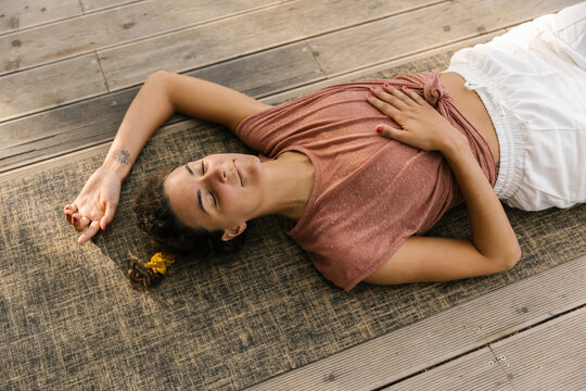 Woman Lying On The Mat, Enjoying Her Time