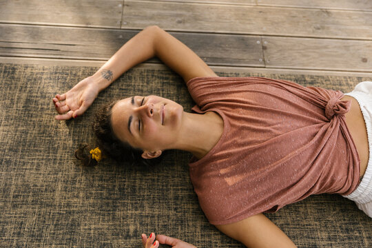 Woman Lying On The Mat, Enjoying Her Time