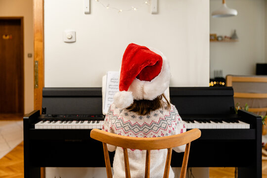 Child playing on piano on Christmas eve 