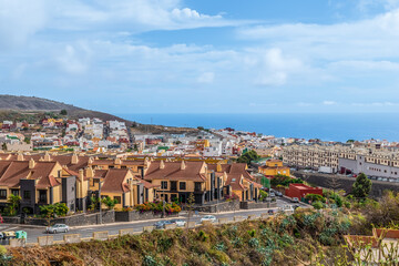 Fototapeta na wymiar San Cristobal de La Laguna, Spain - November 24, 2021: Aerial panorama of La Laguna town with Atlantic Ocean on the horizon. Top view of the rooftops of the Canarian city on the island of Tenerife
