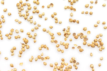 coriander seeds border top view on white background.