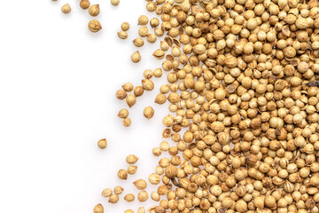 coriander seeds border top view on white background.