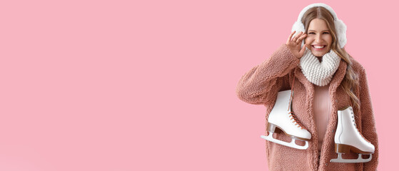 Beautiful young woman with ice skates on pink background with space for text