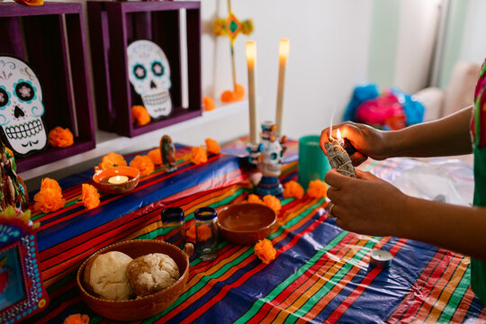 Female hands lighting palo santo "Dia de Muertos"