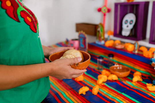 woman  holding bread for ofrenda's altar