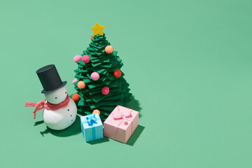 merry christmas and chirstmas tree on color background