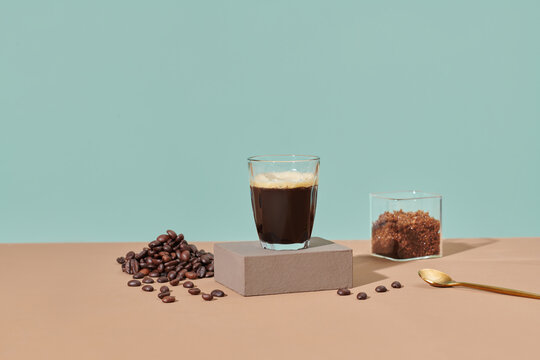 Double wall glass cup with coffee on brown table