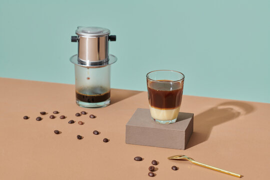 Coffee dripping into the glass with condensed milk