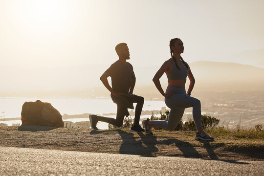 Fitness, beach and couple doing a lunge exercise for health, wellness and training in nature. Motivation, sports and healthy man and woman athletes doing an outdoor workout by the ocean at sunset.