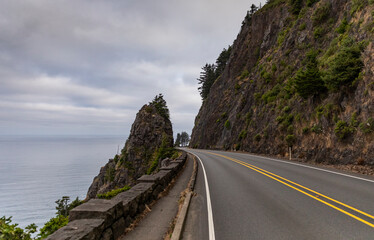 Beautiful rugged Cloudy Oregon Coastline with winding road landscape